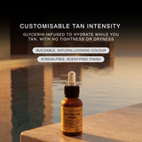 A bottle of Dr Sebagh Self-Tanning Drops stands on a stone ledge with water and a warm sunset background.
